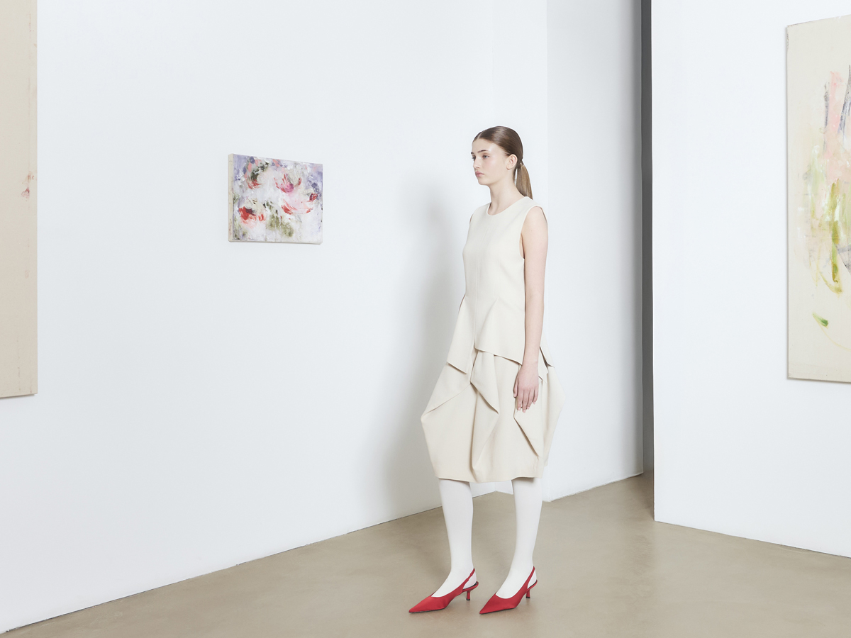 Stockholm pop-up — model in cream dress in a gallery room