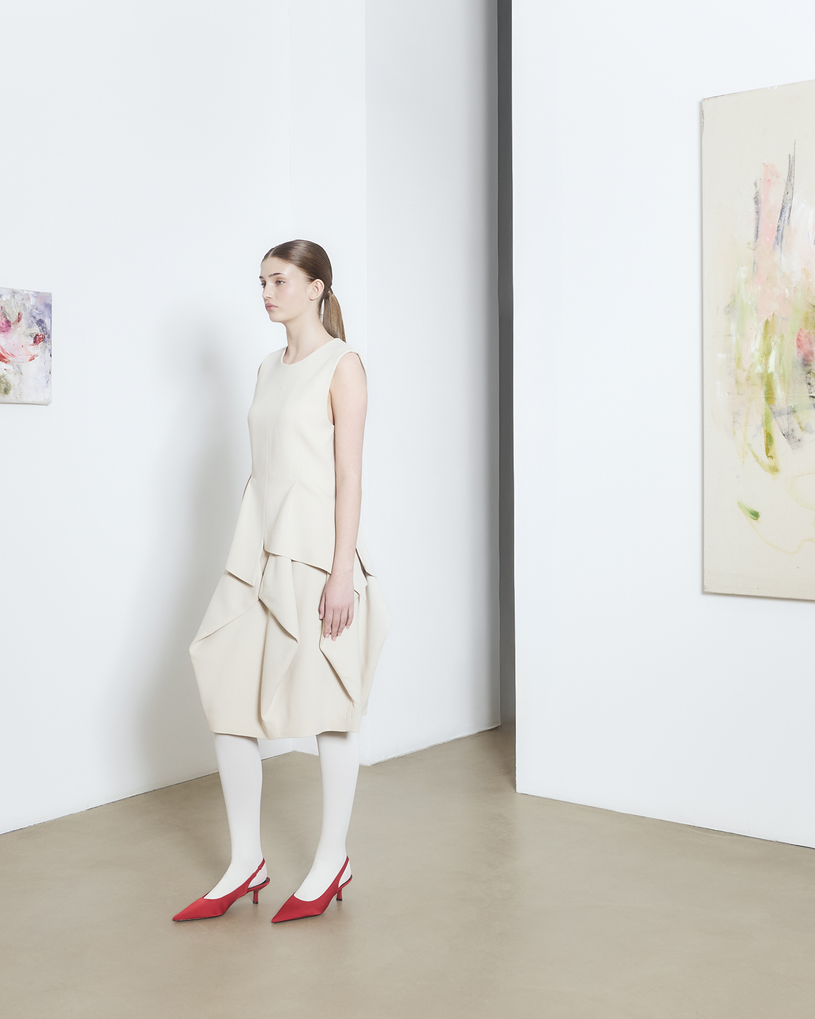 Stockholm pop-up — model in cream dress in a gallery room